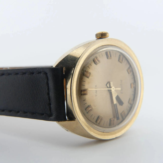 Vintage Timex Electric with champagne dial, gold case, Swiss, and black leather strap