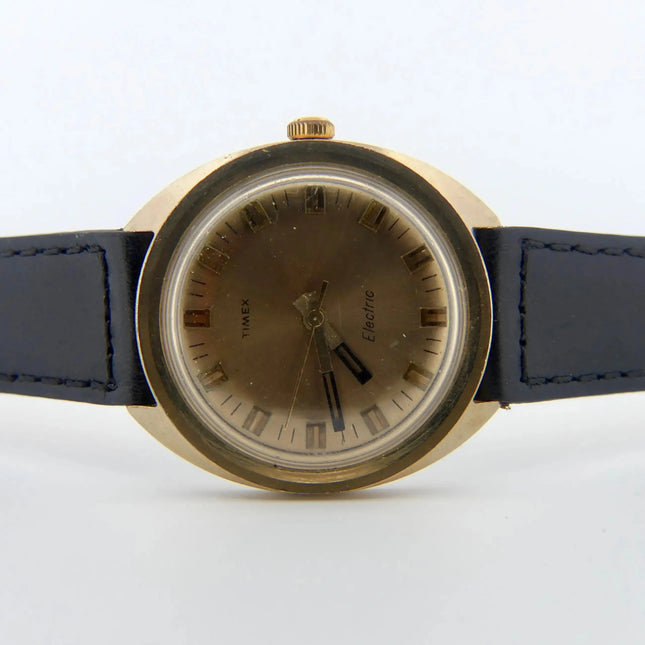 Vintage Timex Electric Swiss watch gold case, black strap, champagne dial